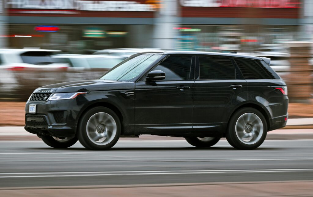 Black SUV driving on city street