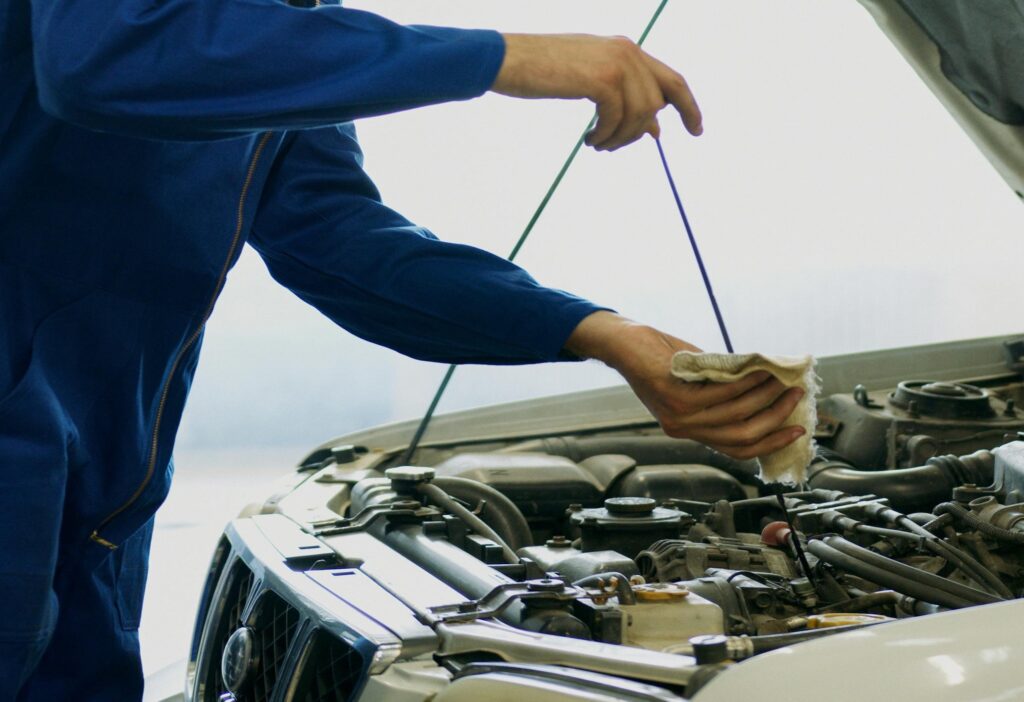 Mechanic checking oil level