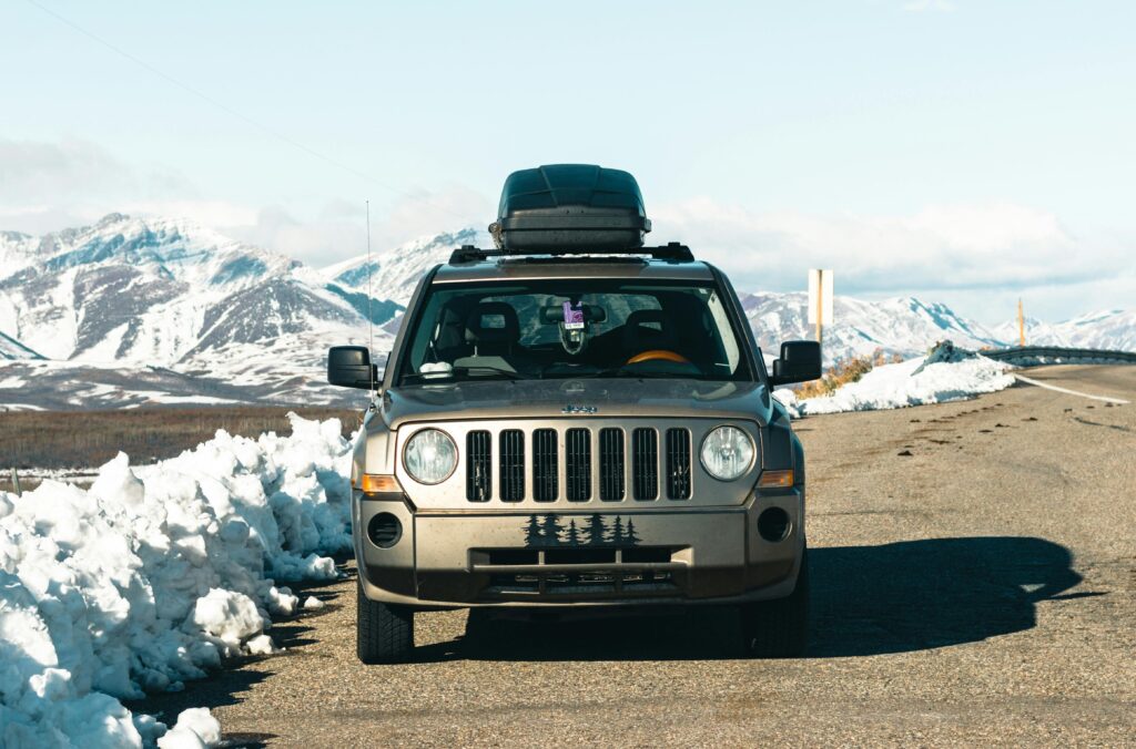 SUV parked on snowy mountain road