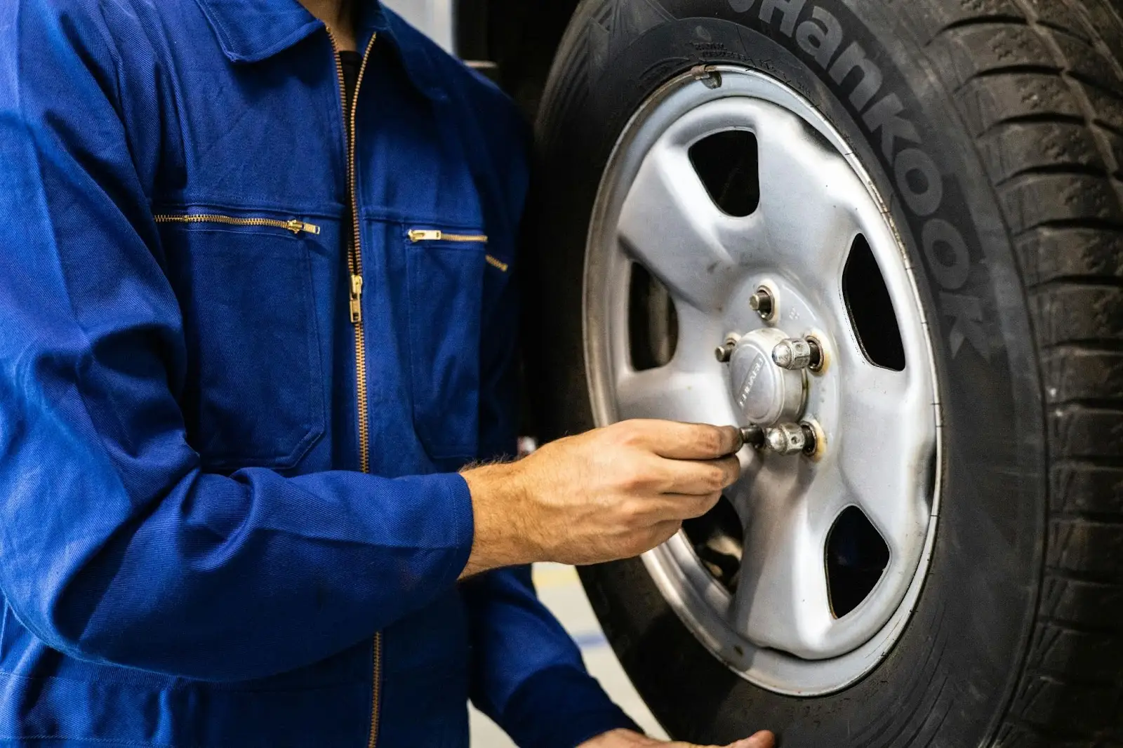 Mechanic working on vehicle wheel