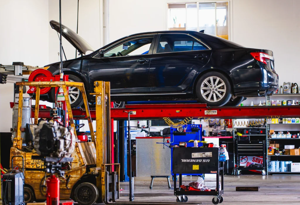 Car on lift in auto repair shop
