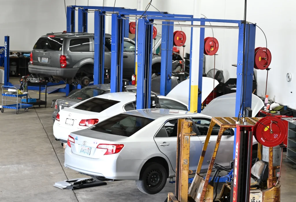 Cars in a repair shop garage.