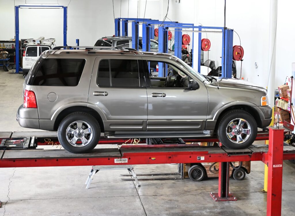 SUV on lift in auto repair shop