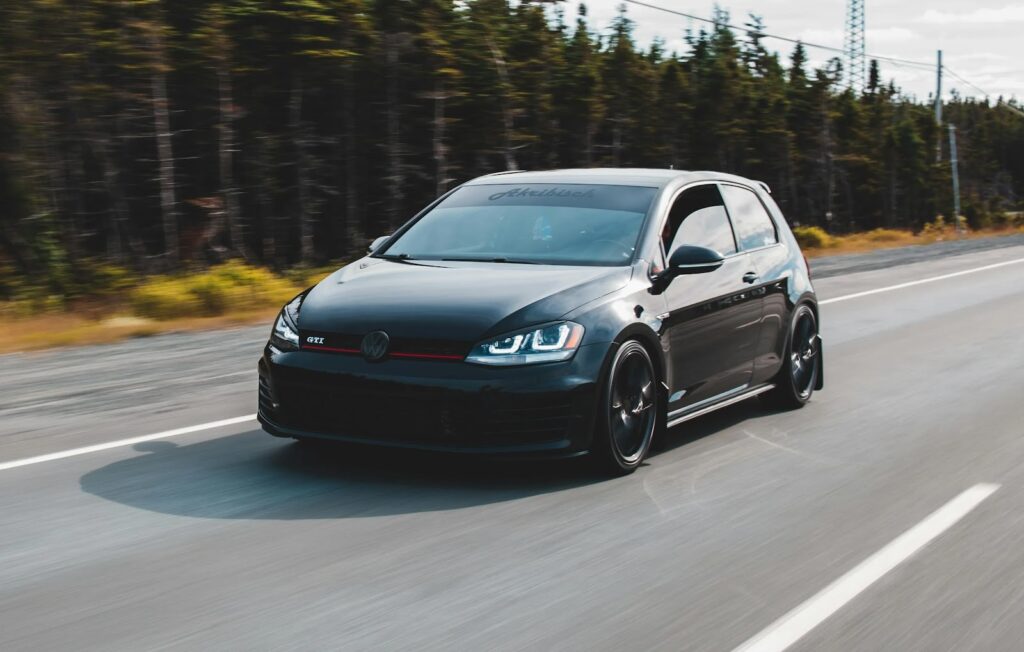 Black car speeding on highway