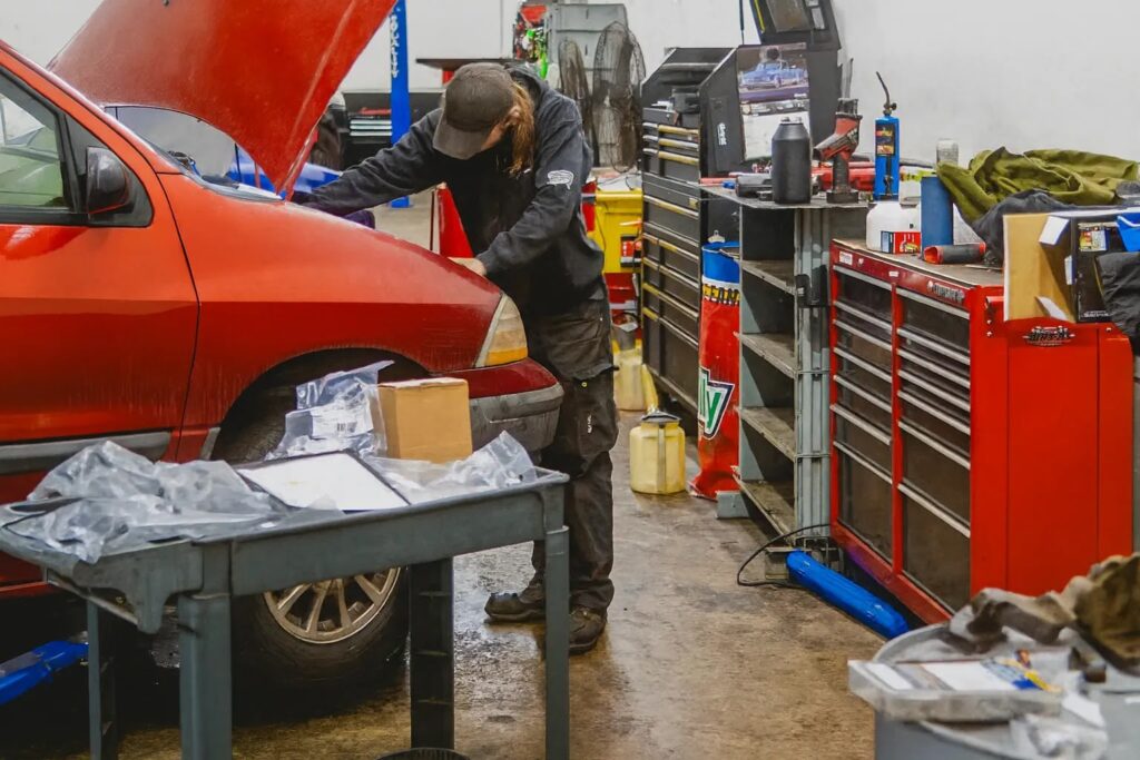Mechanic working on red car