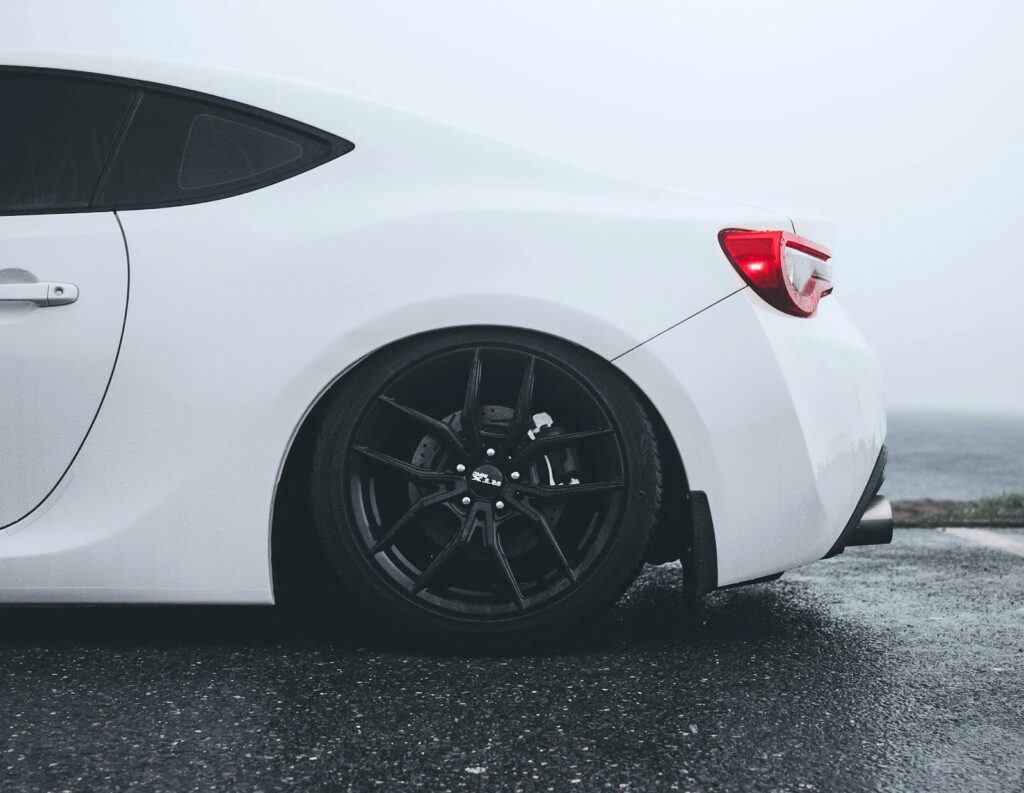 White car with black wheels parked